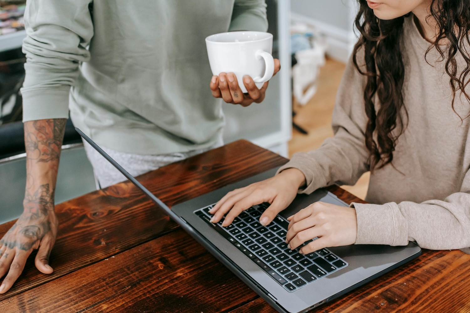 Two people on a computer making money through affiliate marketing.