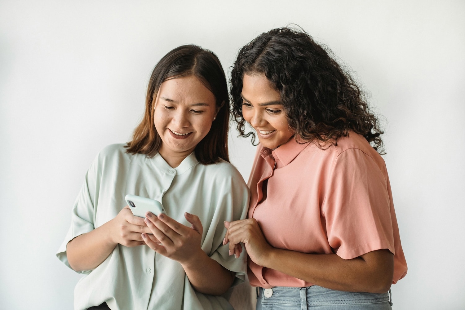 Two friends researching how to get more followers on TikTok.